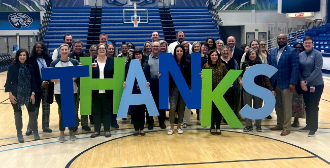 Members of Philanthropy and Alumni Engagement stand on the basketball court to film a special Augusta Gives thank you video.