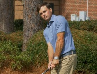 male golfer holds club