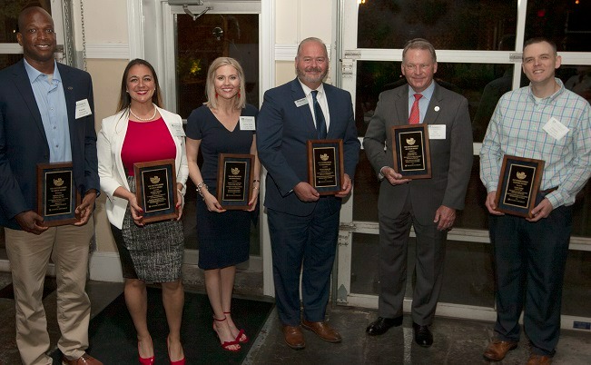 Distinguished alumni display their awards as they are recognized during Alumni Weekend 2022.