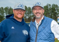 two men standing at baseball field