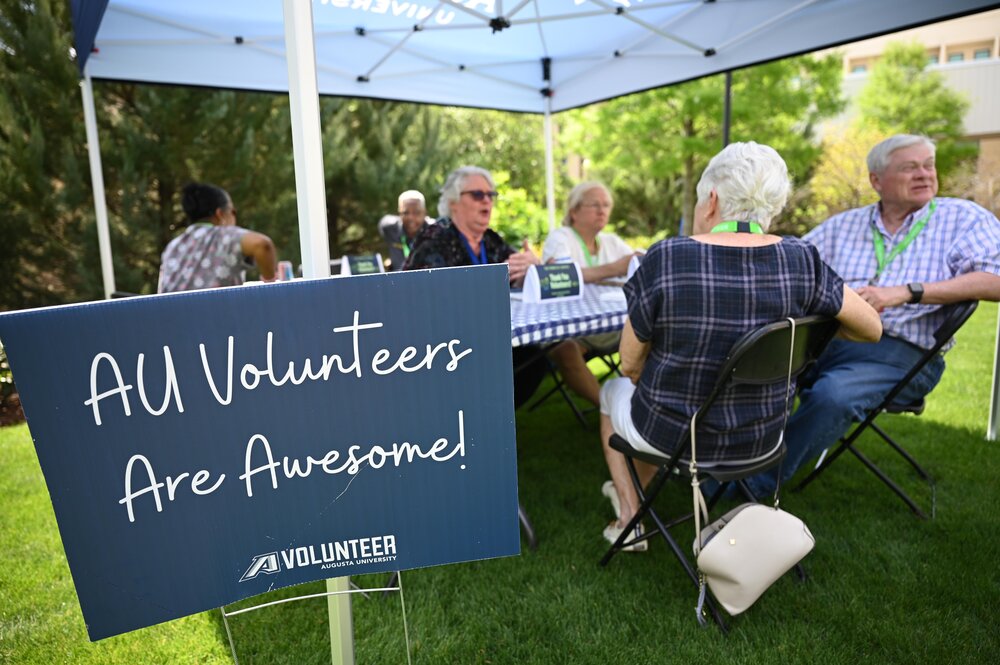 Volunteers are treated to a picnic under a tent outside AU Medical Center.