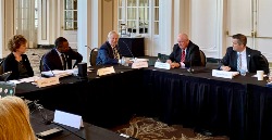 Chancellor and three others seated at table