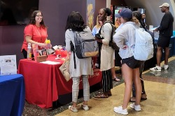 students at information table