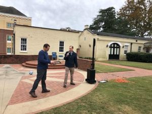 Dr. Sadenwasser presents Dr. Bryant with an award in the Quad Courtyard