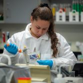 A public health researcher works in a lab