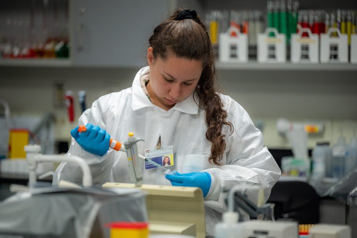 A public health researcher works in a lab