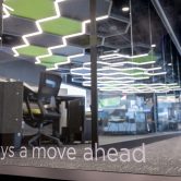 Looking through a glass door into a room with computers and office equipment