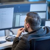 Cybersecurity professional works at a computer