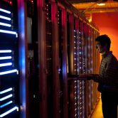 An IT engineer configuring the servers in a data center.