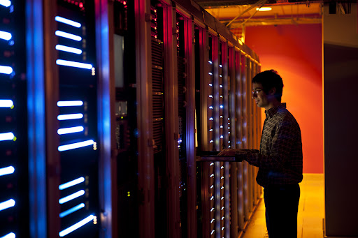 An IT engineer configuring the servers in a data center.