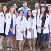 Class of 2024 in their white coats.