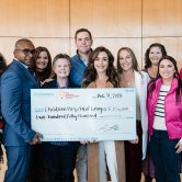 Smiling people receiving large check