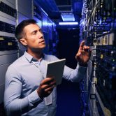 An IT auditor inspects a company’s network servers.
