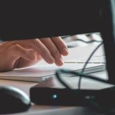 Security professional typing on computer