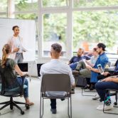 An educational consultant meets with a group of teachers.
