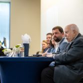 The alumni panelists sit at a table