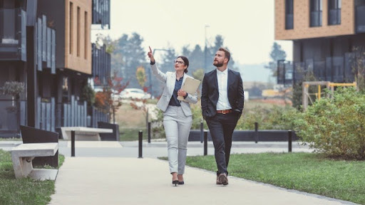 Two urban planners walk through a new development.