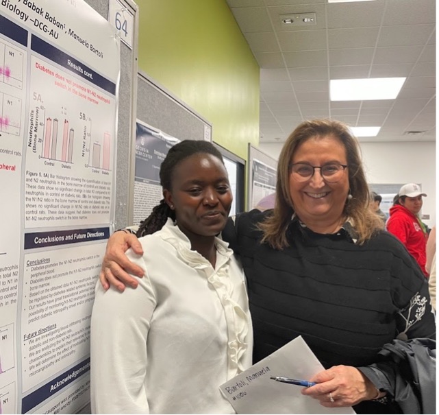 Sheila Ngumbi (BCB) with her mentor, Dr. Manuela Bartoli, at the GRD 2024 Poster Session