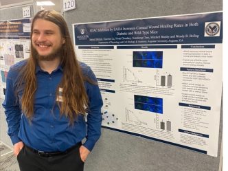 Sam Melnyk (Physiology), captured immediately after a poster presentation