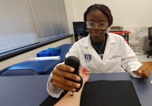 Lydia Utomwen performing research in the lab