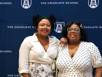 two students pose at welcome back event