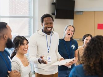 A community health worker meets with a group of volunteers.