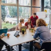 People sitting at a table during an employee cybersecurity training session.