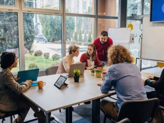 People sitting at a table during an employee cybersecurity training session.