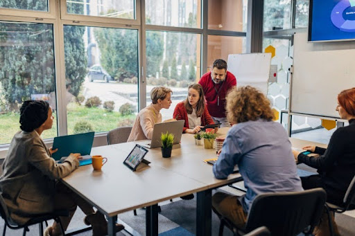 People sitting at a table during an employee cybersecurity training session.