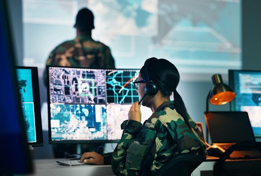 A military intelligence analyst reviews surveillance maps on a monitor.