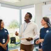 A community service manager speaks to a group of volunteers.