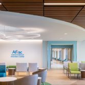 A hospital lobby with blue and green furniture