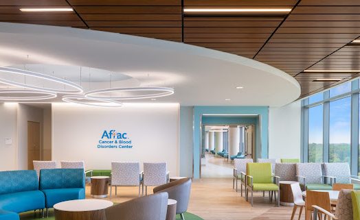 A hospital lobby with blue and green furniture