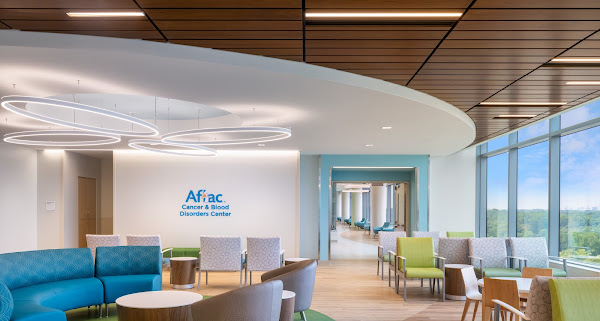 A hospital lobby with blue and green furniture