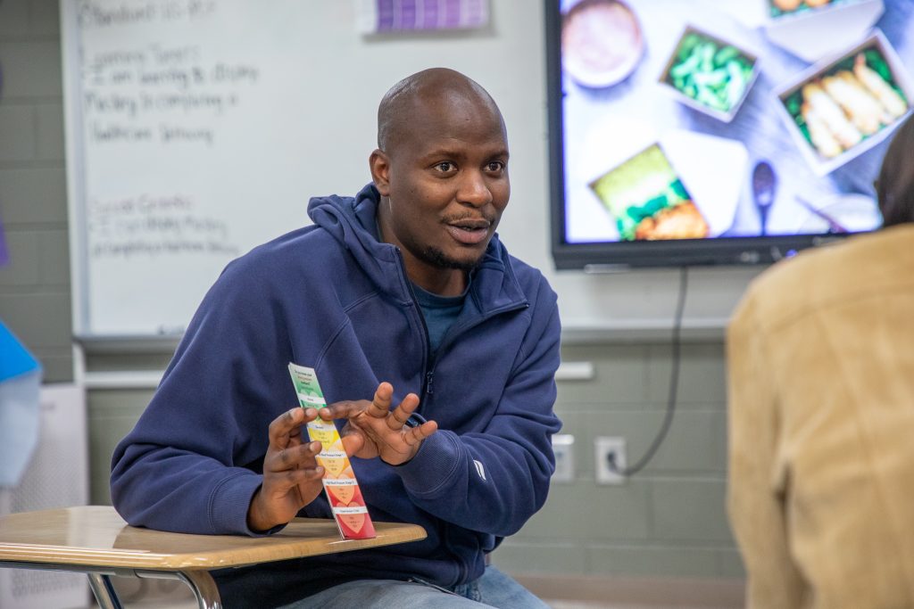 postdoctoral fellow, desmond moronge, teaches students about blood pressure readings.