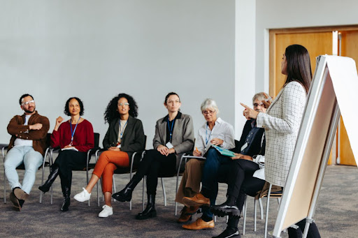 An educational consultant gives a presentation to a group of teachers and school staff.