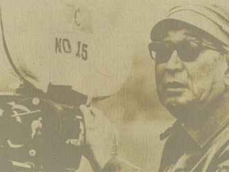 An old fashioned photograph of a man holding a vintage film camera