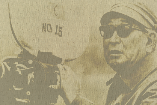 An old fashioned photograph of a man holding a vintage film camera