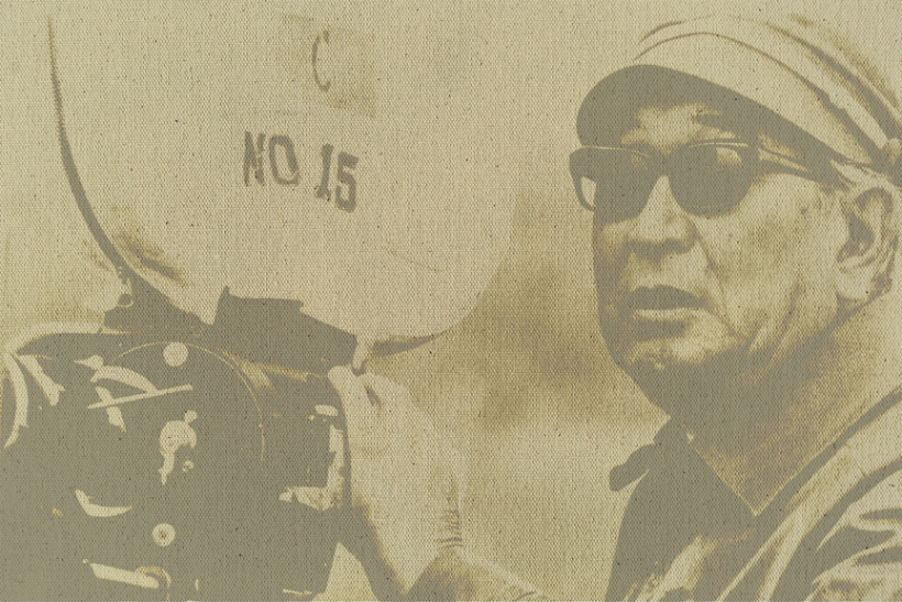 An old fashioned photograph of a man holding a vintage film camera