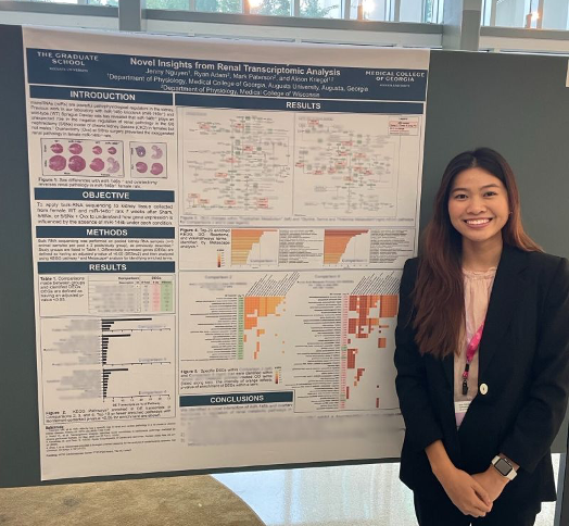 Jenny Nguyen smiling in front of research poster