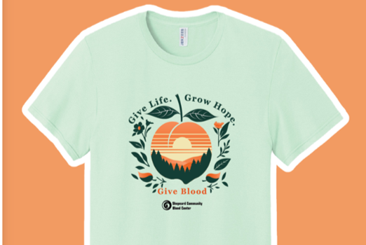 Image of a pale green T-shirt with peach imagery related to the blood donation