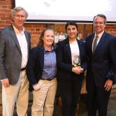 AU faculty honor award winner, stand in a group and smile.