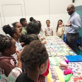 Community health education coordinator talks with children.