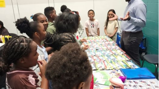Community health education coordinator talks with children.