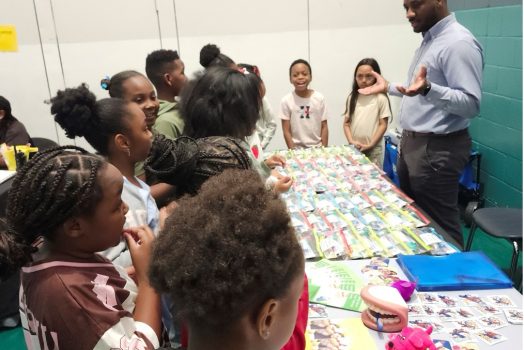 Community health education coordinator talks with children.