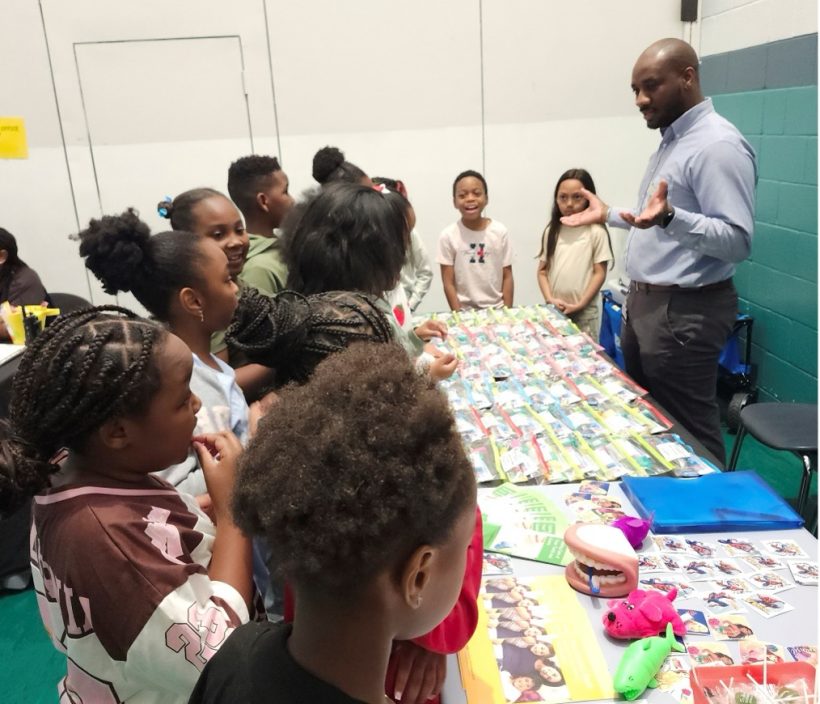 Community health education coordinator talks with children.