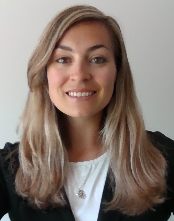 A woman smiles at the camera.