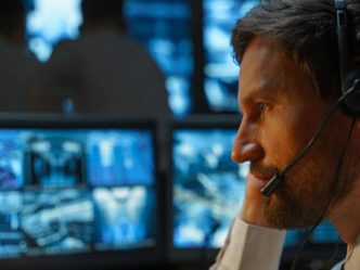 An intelligence officer examines security data on a computer.