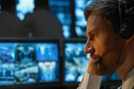An intelligence officer examines security data on a computer.
