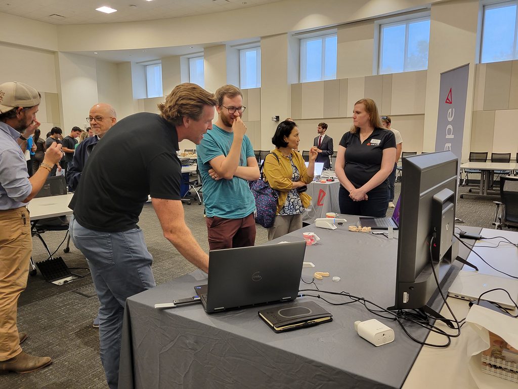 DCG Students and faculty review scanners from several companies.
